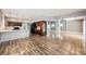 Open-concept kitchen boasts an island with counter seating and wood floors into the dining and living area at 209 Camino Vista St, Henderson, NV 89012