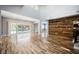 Spacious living room with wood accent wall and backyard access through glass doors at 209 Camino Vista St, Henderson, NV 89012