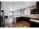 Open concept living room featuring a fireplace and a modern kitchen at 209 Camino Vista St, Henderson, NV 89012