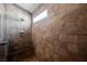 Walk-in shower with tile walls, a built-in bench, and a shower head at 209 Camino Vista St, Henderson, NV 89012