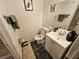 Compact bathroom featuring toilet, sink, vanity, and shower with updated fixtures at 2200 Comet Ave # D, North Las Vegas, NV 89030