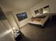 Spacious bedroom with a comfortable bed, mirror and window view at 2200 Comet Ave # D, North Las Vegas, NV 89030