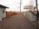 View of the backyard featuring a gravel ground cover and a wooden fence at 2409 Maroney Ave, Las Vegas, NV 89104