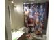 Bathroom featuring a vanity with chrome fixtures, a toilet, and festive shower curtain at 2409 Maroney Ave, Las Vegas, NV 89104