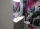 Bathroom featuring a vanity with a chrome faucet and a vibrant peacock themed shower curtain at 2409 Maroney Ave, Las Vegas, NV 89104