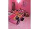 Pink bedroom with a car shaped bed and many stuffed animals creating a playful and inviting space at 2409 Maroney Ave, Las Vegas, NV 89104