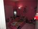 Pink bedroom featuring unique car bed, plush carpet, and whimsical decorations for a playful atmosphere at 2409 Maroney Ave, Las Vegas, NV 89104
