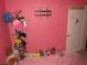 Pink bedroom with a tv mount and assorted stuffed animals for a cozy and playful atmosphere at 2409 Maroney Ave, Las Vegas, NV 89104