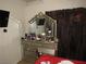 Bedroom features a vanity area with decorative mirror and dresser providing ample storage at 2409 Maroney Ave, Las Vegas, NV 89104