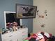 Bedroom with a large mirror on a dresser, walls with applied art, and personal items displayed at 2409 Maroney Ave, Las Vegas, NV 89104
