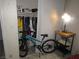 Organized closet featuring clothing rack, shelving, and floor space for storage; bike stored in room at 2409 Maroney Ave, Las Vegas, NV 89104