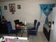 Dining area with round glass table, blue chairs, and tiled floor at 2409 Maroney Ave, Las Vegas, NV 89104