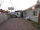 Exterior view showcasing the side of the house with a gravel ground cover and privacy wall at 2409 Maroney Ave, Las Vegas, NV 89104
