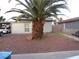 The home has a mature Palm Tree in the low-maintenance rock front yard at 2409 Maroney Ave, Las Vegas, NV 89104