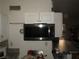 Practical kitchen featuring a microwave and storage cabinets for efficient meal preparation at 2409 Maroney Ave, Las Vegas, NV 89104
