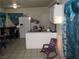 Cozy kitchen area with white appliances and neutral tile flooring provides a functional space at 2409 Maroney Ave, Las Vegas, NV 89104