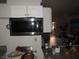 Modest kitchen showcasing a black microwave and a view into the living area with holiday decorations at 2409 Maroney Ave, Las Vegas, NV 89104