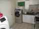 Combined laundry and kitchen area featuring a washer, dryer, and a practical sink space at 2409 Maroney Ave, Las Vegas, NV 89104