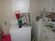 Practical laundry room with a washer, dryer, and storage, accented with decorations and cleaning supplies at 2409 Maroney Ave, Las Vegas, NV 89104