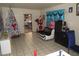 Simple living room with tile floors, a Christmas tree, and blue-themed decor at 2409 Maroney Ave, Las Vegas, NV 89104