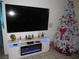 The living room features an electric fireplace and large screen television at 2409 Maroney Ave, Las Vegas, NV 89104