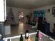 Open living room featuring tile floors, a decorated Christmas tree, and blue-themed curtains at 2409 Maroney Ave, Las Vegas, NV 89104