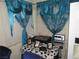 Small office space with a mixing console, laptop and framed photos under bright blue curtains at 2409 Maroney Ave, Las Vegas, NV 89104