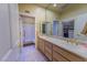 Bathroom featuring double sinks, a shower behind glass door, and large mirror at 2437 Desert Butte Dr, Las Vegas, NV 89134