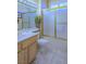 Bathroom featuring a bright vanity, a sliding glass shower, and tiled floors at 2437 Desert Butte Dr, Las Vegas, NV 89134