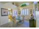 Cozy dining area with a glass table, patterned chairs, and an elegant chandelier at 2437 Desert Butte Dr, Las Vegas, NV 89134