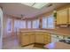 Functional kitchen featuring laminate counters, bright cabinets, and an adjacent dining area at 2437 Desert Butte Dr, Las Vegas, NV 89134