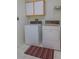 Laundry room area featuring a stacked washer and dryer set and tiled floors at 2437 Desert Butte Dr, Las Vegas, NV 89134