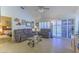 Comfortable living room with tile flooring, plush sofas, and sliding glass doors to the outdoors at 2437 Desert Butte Dr, Las Vegas, NV 89134