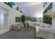Bright living room with high ceilings, carpet flooring, and ample natural light from windows at 2437 Desert Butte Dr, Las Vegas, NV 89134