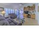 Comfortable living room with tile flooring, plush sofas, and sliding glass doors to the outdoors at 2437 Desert Butte Dr, Las Vegas, NV 89134