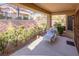 Charming covered patio with seating offering a tranquil garden view and shaded retreat at 2437 Desert Butte Dr, Las Vegas, NV 89134