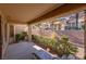 Relaxing covered patio with comfortable chaise lounge and landscaped backyard view at 2437 Desert Butte Dr, Las Vegas, NV 89134