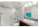 Clean bathroom featuring a shower with glass door, granite vanity, and tiled floors at 245 Hull St, Henderson, NV 89015