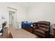 Bedroom featuring a recliner, tiled floors, and windows at 245 Hull St, Henderson, NV 89015
