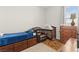 Bedroom featuring a crib, recliner, dresser, and windows at 245 Hull St, Henderson, NV 89015