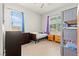 Bright bedroom featuring wood-look flooring, two windows, and built-in bunk beds at 245 Hull St, Henderson, NV 89015