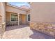 Charming courtyard with a stone-paved patio, covered entrance, and attractive stone accents at 245 Hull St, Henderson, NV 89015