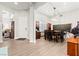 Open entryway with view of the dining room and piano room, wood floors throughout at 245 Hull St, Henderson, NV 89015