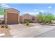 Attractive single-story home featuring a three-car garage, desert landscaping, and stone accents at 245 Hull St, Henderson, NV 89015