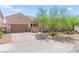 Inviting single-story home featuring stone accents, a well-manicured yard, and a two-car garage at 245 Hull St, Henderson, NV 89015
