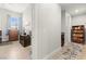 Hallway leading to a bedroom and bathroom featuring hardwood flooring throughout the home at 245 Hull St, Henderson, NV 89015