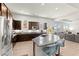 Gourmet kitchen with dark cabinets, granite counters, stainless steel appliances, and eat in bar at 245 Hull St, Henderson, NV 89015