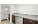 A convenient kitchenette equipped with granite countertops and stainless steel dishwasher at 245 Hull St, Henderson, NV 89015