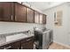 Laundry room with stainless steel washer and dryer and granite countertops at 245 Hull St, Henderson, NV 89015