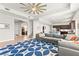 Bright living room with a large gray sectional sofa, ceiling fan, and modern blue rug at 245 Hull St, Henderson, NV 89015